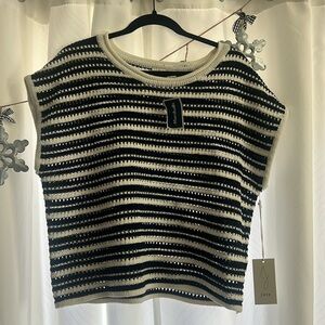 Sweater vest with tags still on it